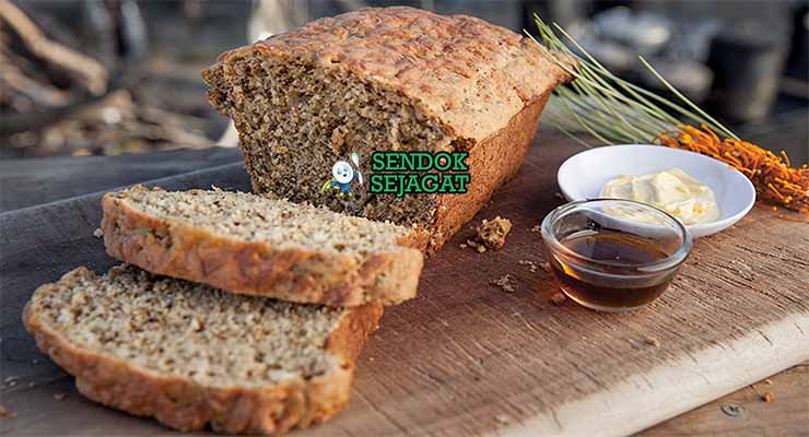 Wattleseed Damper Sendok Sejagat dengan biji wattle.