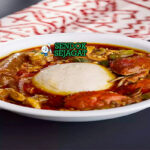 Ghanaian Banku with Okro Stew dengan daging dan cabai garnish
