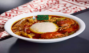 Ghanaian Banku with Okro Stew dengan daging dan cabai garnish