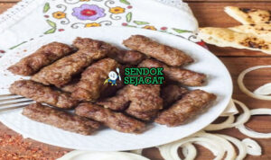 Cevapi Juicy Khas Balkan Cevapi dengan sosis bakar dan roti pita di piring saji