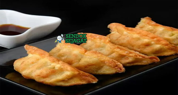 Gyoza dumpling goreng renyah isi daging dengan saus cuka di piring saji