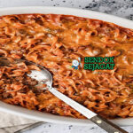 Johnny Marzetti dengan pasta, saus daging, dan keju leleh di piring saji