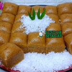 Kue Apem dengan sirup gula merah dan kelapa parut di piring saji