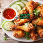 Gai Tod ayam golden renyah saus pedas cabai di piring saji