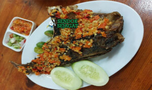 Ikan Bakar Manado tuna utuh rica dabudabu tomat hijau di daun pisang