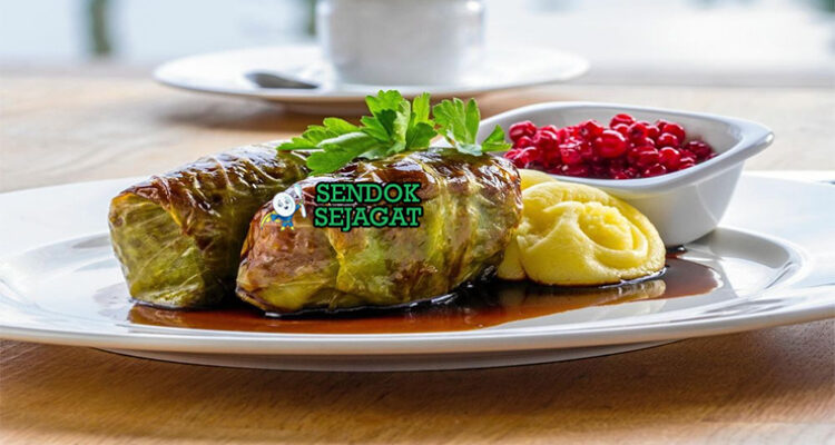 Kåldolmar Kubis Gulung isi daging saus krim lingonberry di piring saji