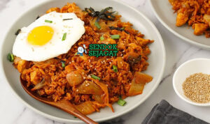 Kimchi Bokkeumbap Pedas Nagih Khas Korea Kimchi Bokkeumbap nasi merah pedas kimchi telur runny nori wijen daun bawang di wajan panas