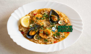 Arroz de Marisco Gurih Laut Khas Portugal Arroz de Marisco nasi kuning saffron seafood udang cumi kerang tomat paprika coentros lemon roti
