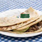 Baleada lipat setengah isi refried beans crema queso fresco telur ayam aguacate salsa roja