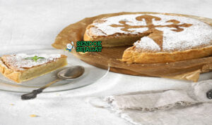 Torta de Santiago Lembut Harum Khas Galicia Spanyol Torta de Santiago kue almond golden motif cruz salib gula bubuk potong segitiga lemon slice teh