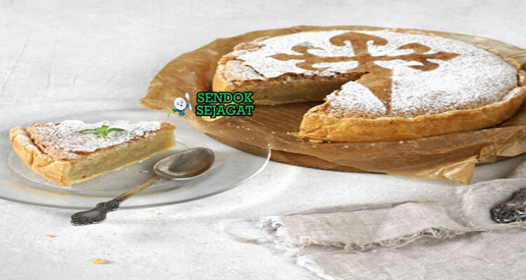 Torta de Santiago kue almond golden motif cruz salib gula bubuk potong segitiga lemon slice teh