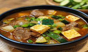 Doenjang-jjigae sup kedelai kental tofu zucchini bawang bombay daun bawang wijen ddukbaekgi nasi kimchi