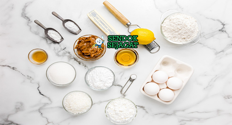Bahan-bahan resep Alfajores termasuk tepung terigu, maizena, mentega, gula bubuk, susu kental manis, dan vanila siap dibuat