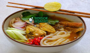 Laksa Medan khas Sumatera Utara siap saji: mangkuk mie kuning kenyal dengan kuah santan kuning kental gurih, ayam suwir lembut, telur rebus, tahu goreng, tauge segar, bawang goreng, dan kerupuk, terlihat menggoda dengan uap hangat