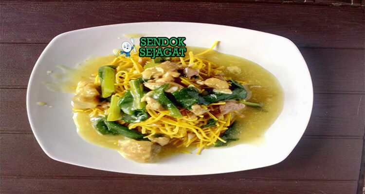 Mie kering khas Makassar siap saji: mie kuning kenyal terbalut bumbu kacang manis gurih berwarna cokelat kental, kikil sapi empuk, bakso urat, tauge segar, telur rebus, bawang goreng tabur, dan kerupuk emping, terlihat menggoda dengan warna cerah