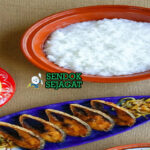 Mangkok Panta Ilish khas Bangladesh dengan nasi fermentasi dingin, ikan hilsa goreng renyah, bawang iris, cabai hijau, dan jeruk nipis, tampak segar gurih menggugah selera