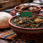 Afang soup khas Nigeria dengan sup sayur hijau kental berisi daging sapi, periwinkle, dan ikan kering, disajikan hangat di mangkuk tradisional