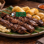 Anticuchos de Corazón khas Peru dengan tusuk jantung sapi panggang kecokelatan, saus pedas, kentang rebus, tampak gurih menggugah selera