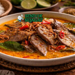 Gulai Limpa khas Padang dengan limpa sapi empuk, kuah santan kental kuning, tampak gurih hangat menggugah selera