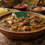 Ogbono soup khas Nigeria dengan kuah hijau kental berisi daging sapi, periwinkle, dan daun ugu segar, disajikan hangat di mangkuk tradisional