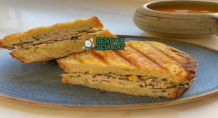 Tuna Melt khas Amerika dengan roti panggang renyah, isian tuna mayo creamy, keju cheddar leleh meluber, tampak gurih hangat menggugah selera