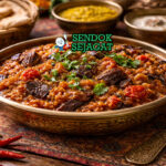 Baingan ka bharta khas India dengan terong bakar dihaluskan menjadi creamy, dicampur bawang, tomat, dan rempah India, disajikan hangat di mangkuk